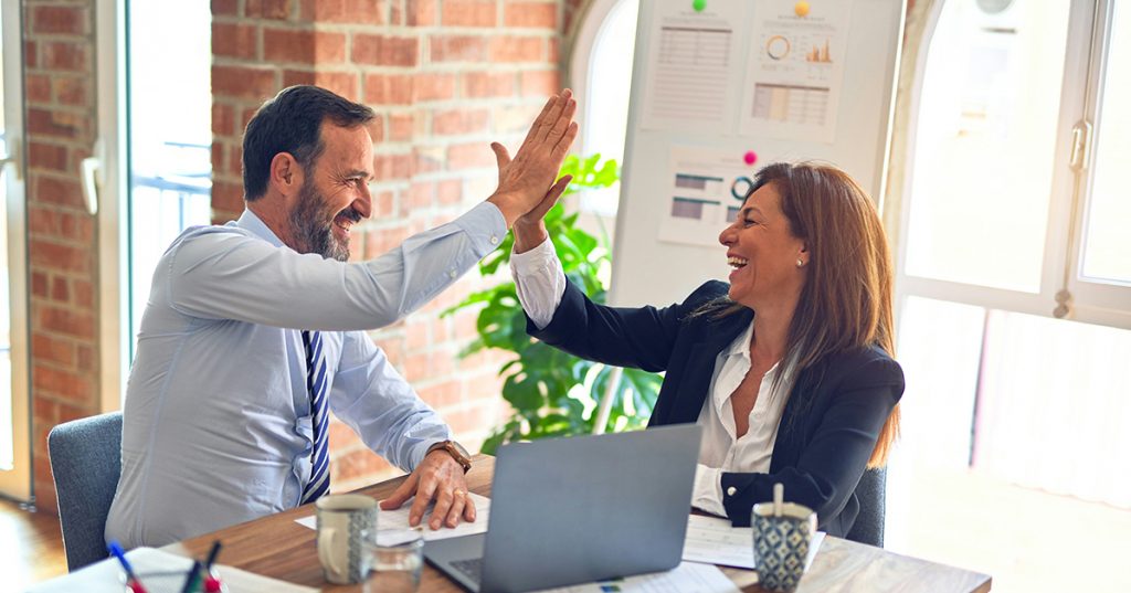 Real estate agents collaborating and sharing strategies at a team meeting