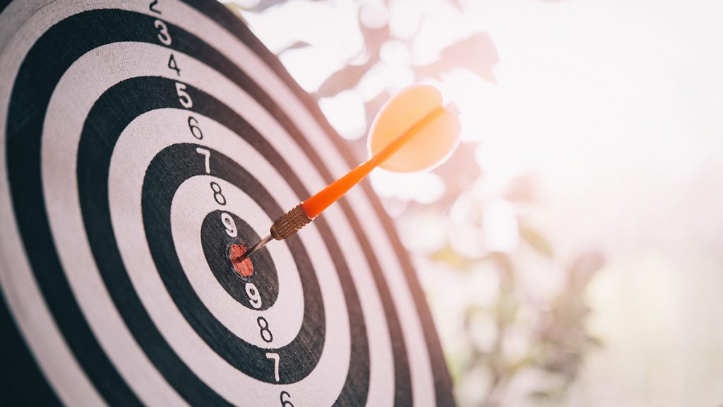 Real estate agent comparing marketing company options on a laptop