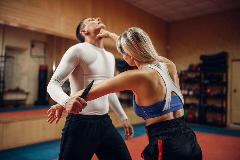 A man and woman practicing self-defense skills
