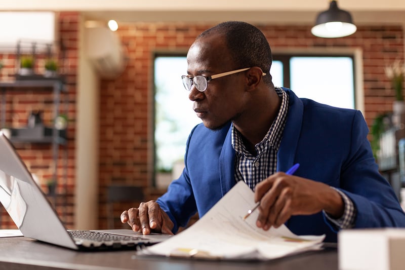 Professional man working on a laptop in an office